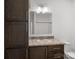 Bathroom with dark brown vanity, single sink, and a shower/tub combo at 5605 Miami Ln, Concord, NC 28025