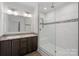 Modern bathroom with double vanity, large shower, and marble tile accents at 5605 Miami Ln, Concord, NC 28025