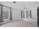 Spacious bedroom with grey carpet, ceiling fan and multiple windows at 5605 Miami Ln, Concord, NC 28025