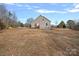 House exterior showcasing a side view and spacious yard at 5605 Miami Ln, Concord, NC 28025