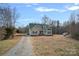 House exterior with gravel driveway and green roof at 5605 Miami Ln, Concord, NC 28025