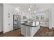 Modern kitchen with white shaker cabinets, stainless steel appliances, and an island at 5605 Miami Ln, Concord, NC 28025