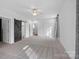 Main bedroom with grey carpet, barn door, and access to other rooms at 5605 Miami Ln, Concord, NC 28025