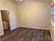 Spacious bedroom with wood-look flooring and access to upstairs at 5732 Prescott Ct, Charlotte, NC 28269