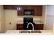 Well-equipped kitchen featuring dark wood cabinets and granite countertops at 5732 Prescott Ct, Charlotte, NC 28269