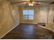 Bright and spacious living room with laminate flooring and ceiling fan at 5732 Prescott Ct, Charlotte, NC 28269