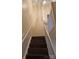 Stairs leading to the upper level with wood-look laminate flooring at 5732 Prescott Ct, Charlotte, NC 28269