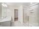 Bright bathroom featuring double sinks and a shower at 5763 Crown Ter, Hickory, NC 28601