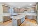 Modern kitchen with gray cabinets, granite island, and white backsplash at 5763 Crown Ter, Hickory, NC 28601