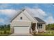 Beige and brown one-story house with a two-car garage and partial brick front at 5775 Crown Ter, Hickory, NC 28601