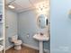 Clean basement bathroom with pedestal sink and tiled floor at 585 Ambergate Nw Pl, Concord, NC 28027