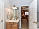 Simple bathroom with single sink vanity and view into living room at 585 Ambergate Nw Pl, Concord, NC 28027