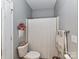 Clean bathroom with shower, toilet and white waffle shower curtain at 585 Ambergate Nw Pl, Concord, NC 28027