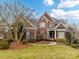 Brick two-story home with landscaped lawn and mature trees at 585 Ambergate Nw Pl, Concord, NC 28027