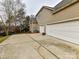 Three-car garage with large driveway and side yard at 585 Ambergate Nw Pl, Concord, NC 28027