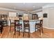 Modern kitchen with granite countertops, white cabinets, and breakfast bar at 585 Ambergate Nw Pl, Concord, NC 28027