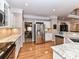 Kitchen features stainless steel refrigerator and granite countertops at 585 Ambergate Nw Pl, Concord, NC 28027