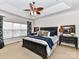 Main bedroom with ceiling fan, large window, and dark wood furniture at 585 Ambergate Nw Pl, Concord, NC 28027