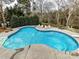 Inviting kidney shaped pool with plenty of space for relaxation at 585 Ambergate Nw Pl, Concord, NC 28027