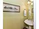 Charming powder room with pedestal sink and decorative art at 585 Ambergate Nw Pl, Concord, NC 28027