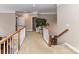 Spacious upstairs hallway with carpeted flooring and wooden railing at 585 Ambergate Nw Pl, Concord, NC 28027