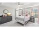 Main bedroom with a canopy bed, dresser, and plenty of natural light at 6033 Creft Cir, Indian Trail, NC 28079