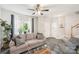 Living room with a gray couch, coffee table and large windows at 6033 Creft Cir, Indian Trail, NC 28079