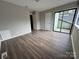 Bedroom with sliding glass doors to balcony and laminate floors at 6126 Bent Tree Ct, Charlotte, NC 28212