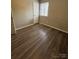 Bedroom with dark laminate flooring and a window at 6126 Bent Tree Ct, Charlotte, NC 28212