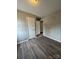 Simple bedroom with wood flooring and two doors at 6126 Bent Tree Ct, Charlotte, NC 28212