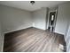 Simple bedroom with laminate wood flooring and an exterior door at 6126 Bent Tree Ct, Charlotte, NC 28212