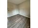 Simple bedroom with laminate floors and an area needing repair at 6126 Bent Tree Ct, Charlotte, NC 28212