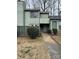 Exterior view of a green townhouse with a walkway and landscaping at 6126 Bent Tree Ct, Charlotte, NC 28212