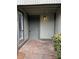 Front entry with a gray door and small porch at 6126 Bent Tree Ct, Charlotte, NC 28212