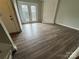 Living room with dark laminate flooring and sliding glass doors at 6126 Bent Tree Ct, Charlotte, NC 28212