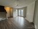 Spacious living room featuring laminate floors and access to a patio at 6126 Bent Tree Ct, Charlotte, NC 28212