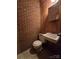 Simple bathroom with brick walls and a tiled floor at 625 Teddar Rd, Mount Gilead, NC 27306