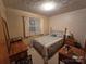 Cozy bedroom with floral bedding and wood furniture at 625 Teddar Rd, Mount Gilead, NC 27306