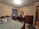 Well-lit bedroom, featuring a wooden dresser and a double bed at 625 Teddar Rd, Mount Gilead, NC 27306