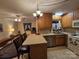 Open kitchen with breakfast bar and stainless steel fridge at 625 Teddar Rd, Mount Gilead, NC 27306