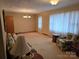 Bright living room with large windows and seating area at 625 Teddar Rd, Mount Gilead, NC 27306