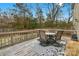 Back deck with table and chairs, surrounded by trees at 7845 Kuck Rd, Mint Hill, NC 28227