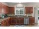 Kitchen with ample counter space, stainless steel sink, and wood cabinets at 7845 Kuck Rd, Mint Hill, NC 28227