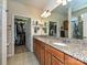 Bathroom with double vanity with granite countertop, glass shelving and walk-in closets at 8024 Carolina Lakes Way, Fort Mill, SC 29707