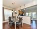 Charming dining area with table seating for four, a chandelier, and kitchen view at 8024 Carolina Lakes Way, Fort Mill, SC 29707