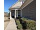 Charming home entrance with a decorative door, white trim, and lush landscaping at 8024 Carolina Lakes Way, Fort Mill, SC 29707