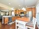 Open kitchen view showcasing an island, stainless steel appliances, and modern finishes at 8024 Carolina Lakes Way, Fort Mill, SC 29707
