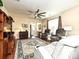 Open-concept living room featuring a large rug, ceiling fan, and comfortable seating at 8024 Carolina Lakes Way, Fort Mill, SC 29707