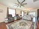 Spacious living room with hardwood floors, plush seating, and a ceiling fan at 8024 Carolina Lakes Way, Fort Mill, SC 29707