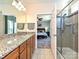 Main bathroom featuring granite countertops, tiled floors, and a glass-enclosed shower at 8024 Carolina Lakes Way, Fort Mill, SC 29707